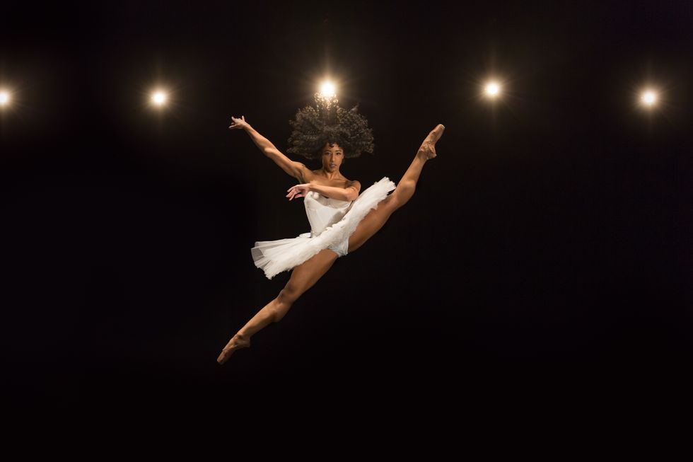 Rachael Parini, wearing a white tutu, does a large split sissone with her legs in second, her left leg higher than her right to create a diagonal. International Vaganova-prix Competition (St. Petersburg, 1991). It's not even expensive metal. </p>, <h4 style=