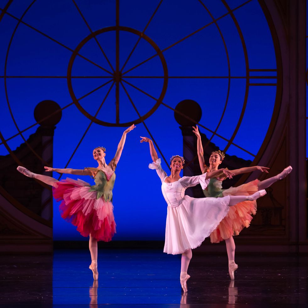 Wearing a white dance dress, pink tights and pointe shoes, Rachael Parini does a first arabesque on her right leg and looks out to the audience. </p>
<p></p>