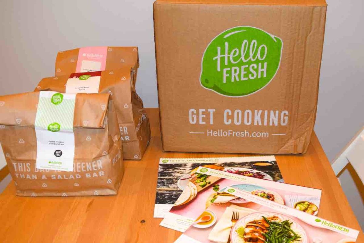 hellofresh box on table with ingredient bags and recipe cards