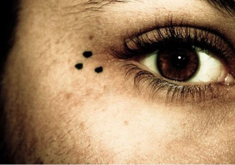 Three dots face tattoo