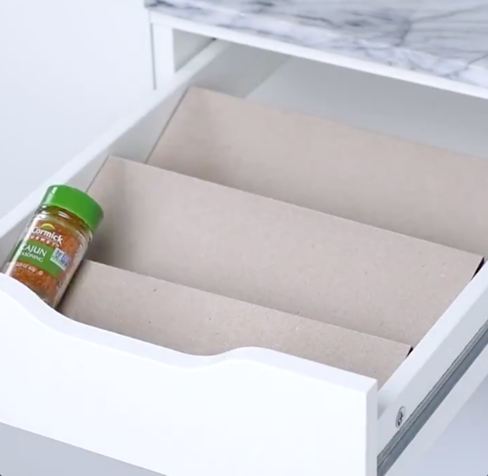 Three ramps in a drawer one after the other. On the first one there's a spice jar.