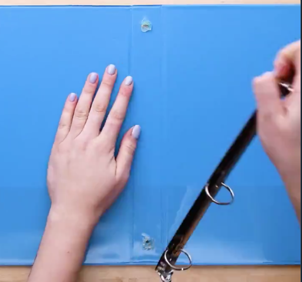 Someone rips the metal rings out of a trapper keeper