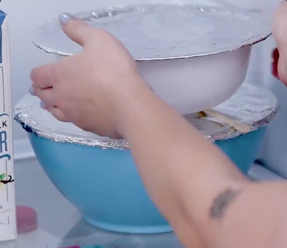 One bowl covered in tinfoil sits easily on top of another bowl covered in tinfoil