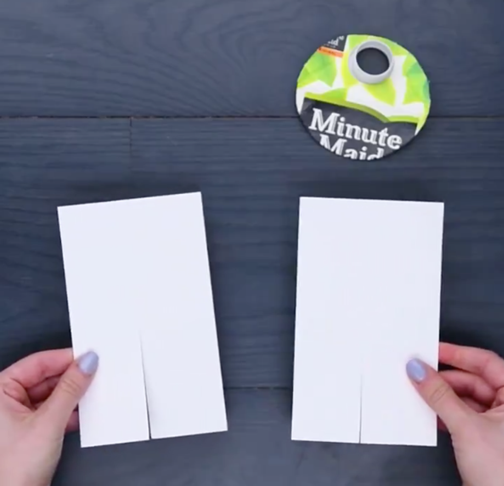 Two rectangles of cardboard with slits plus the circle of orange carton