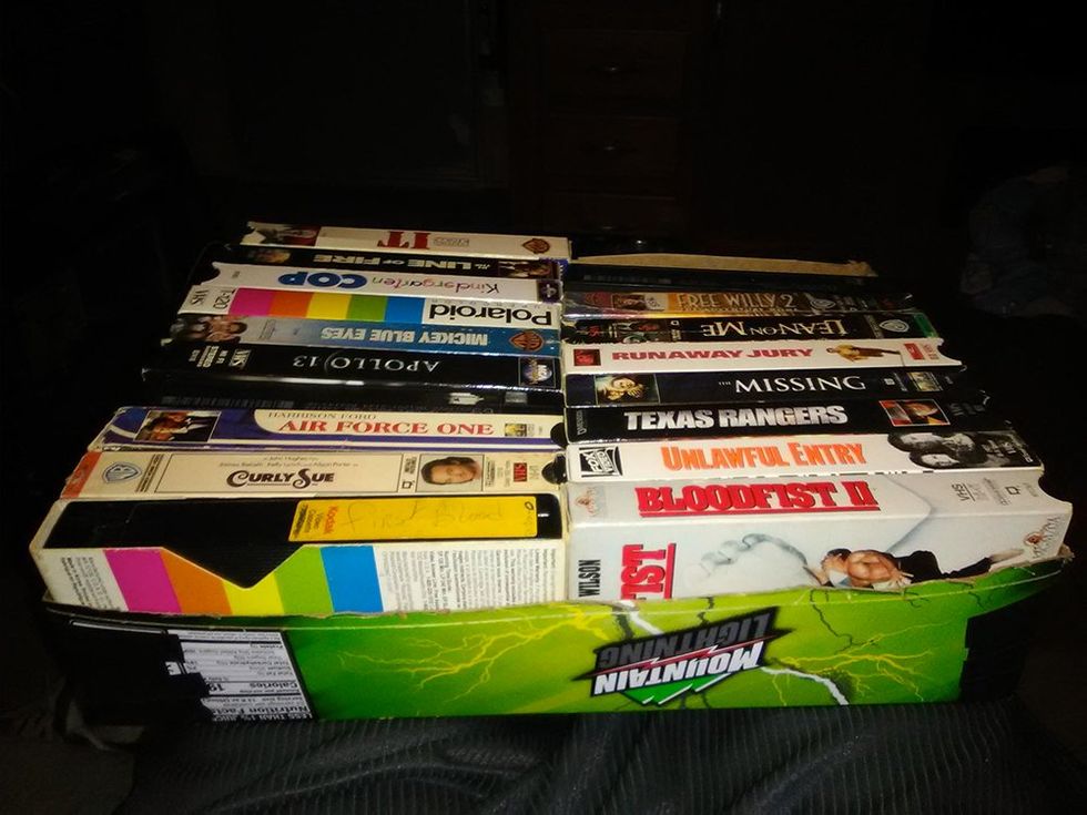 One half a soda box holds VHS tapes