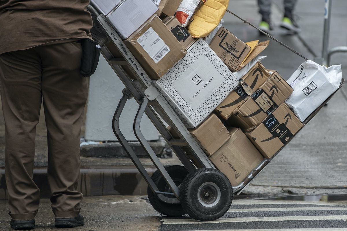 Delivery worker moving a haul of boxes