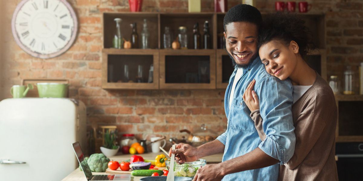 black-couple-hugging-cooking-in-kitchen