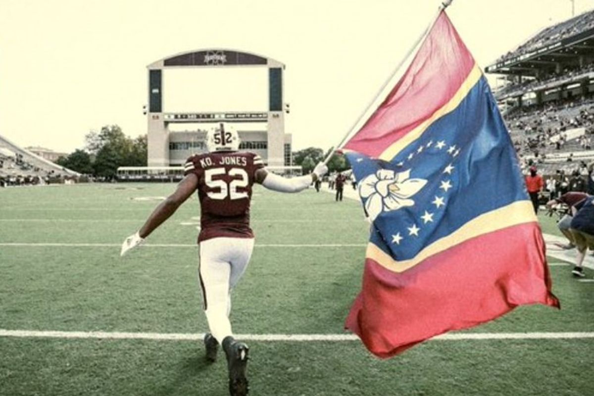 Mississippi State player proudly waves the state's new Confederate-free flag on game day