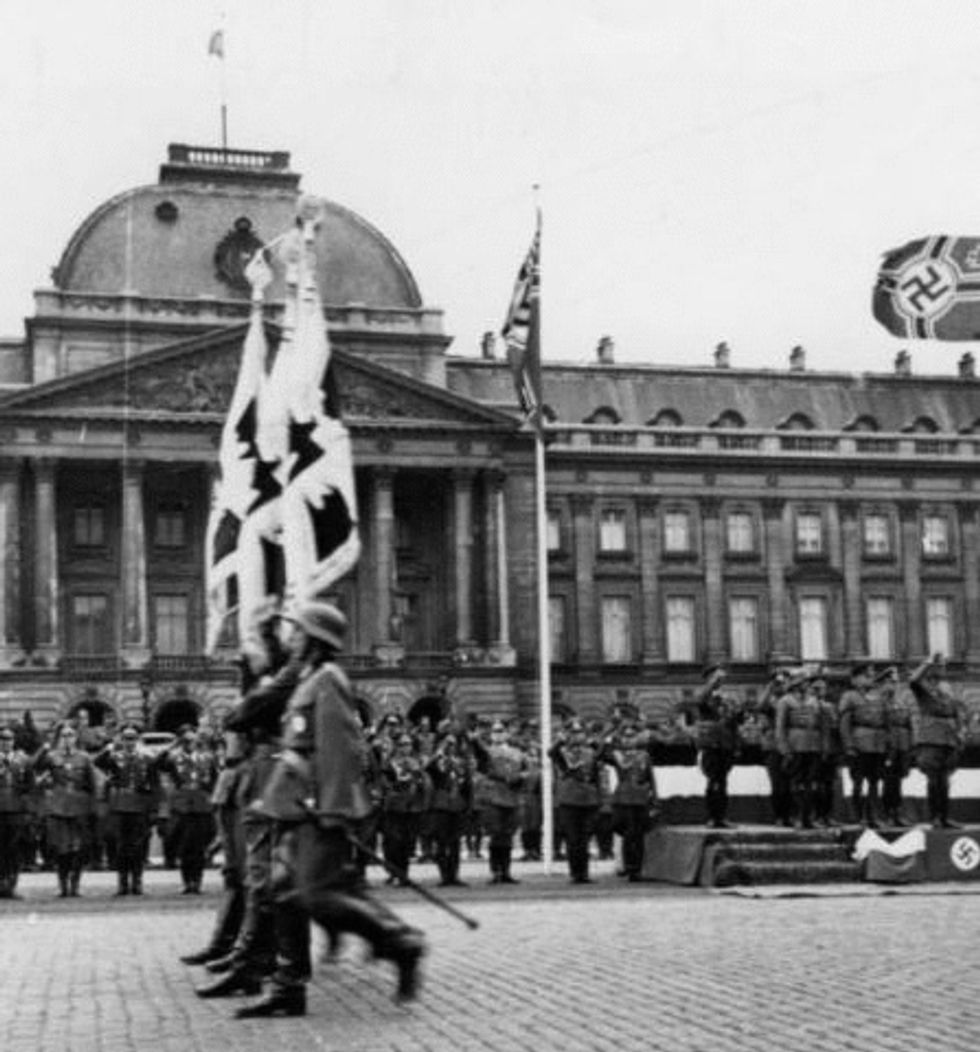 German soldiers parade past the Royal Palace in Brussels, 1940