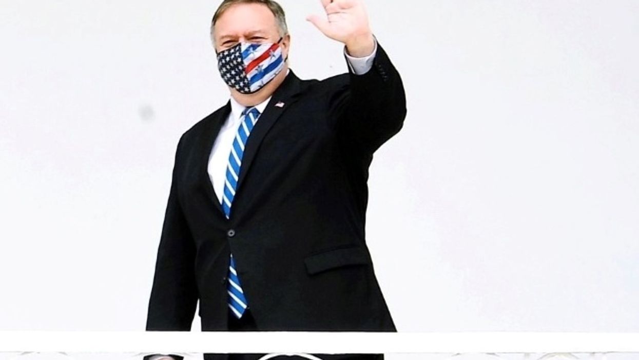 Mike Pompeo waves with mask on. 