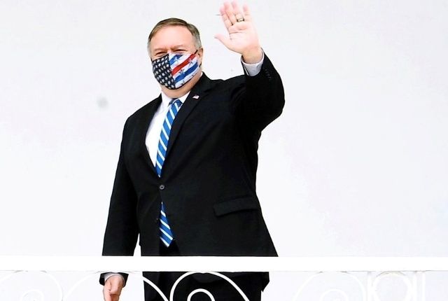 Mike Pompeo waves with mask on. 