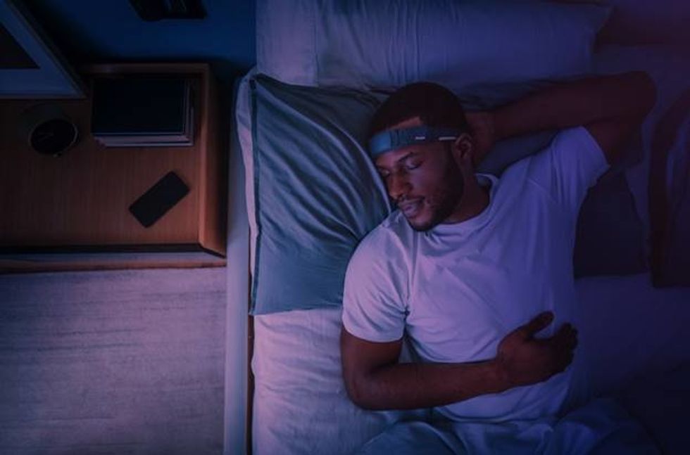 a photo of a man spleeping with Muse S headband on tracking his sleep