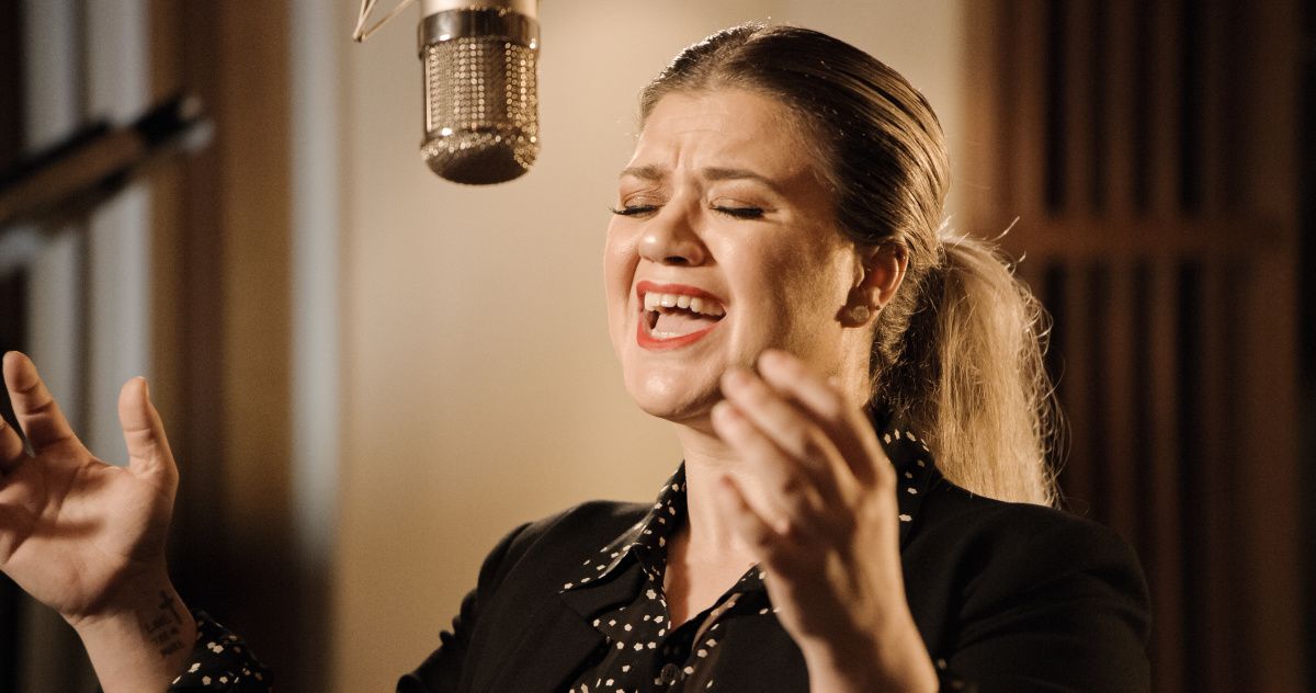 Kelly Clarkson singing at a microphone