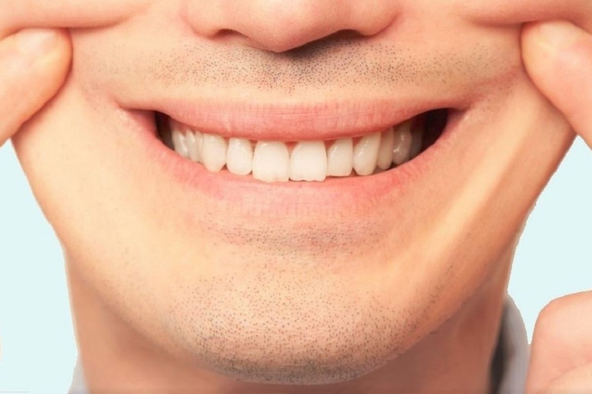 man forcing a smile