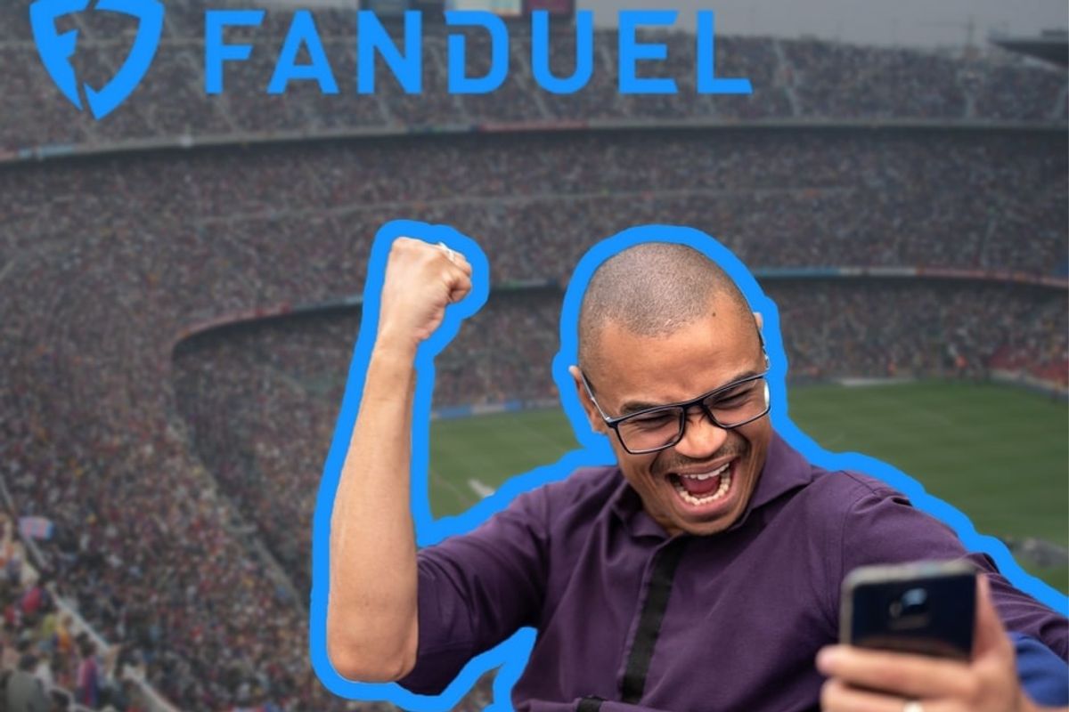 Man looking at phone excitedly with football stadium background