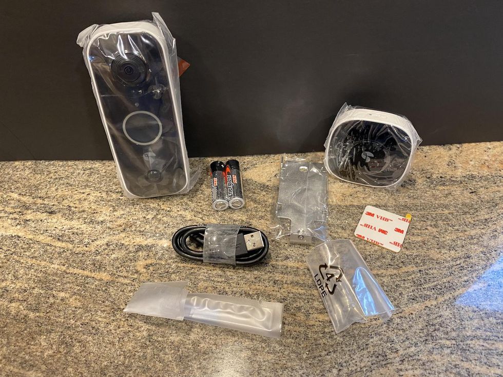 Contents of Toucan Wireless Video Doorbell on a counter