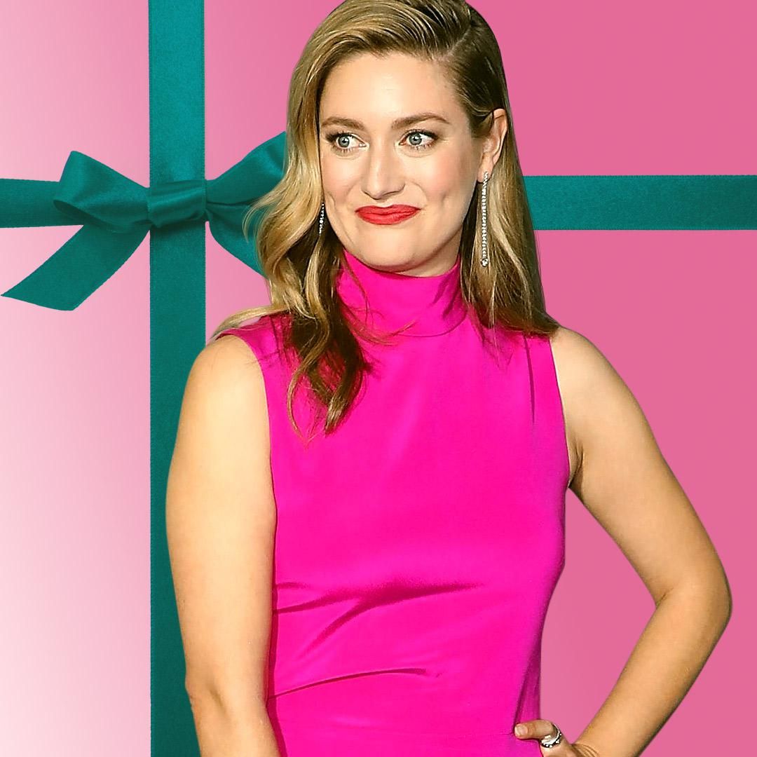 Actress Zoe Perry wears a fuschia colored gown against a lavender backdrop