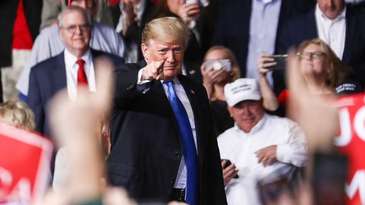 Trump points finger into crowd. 