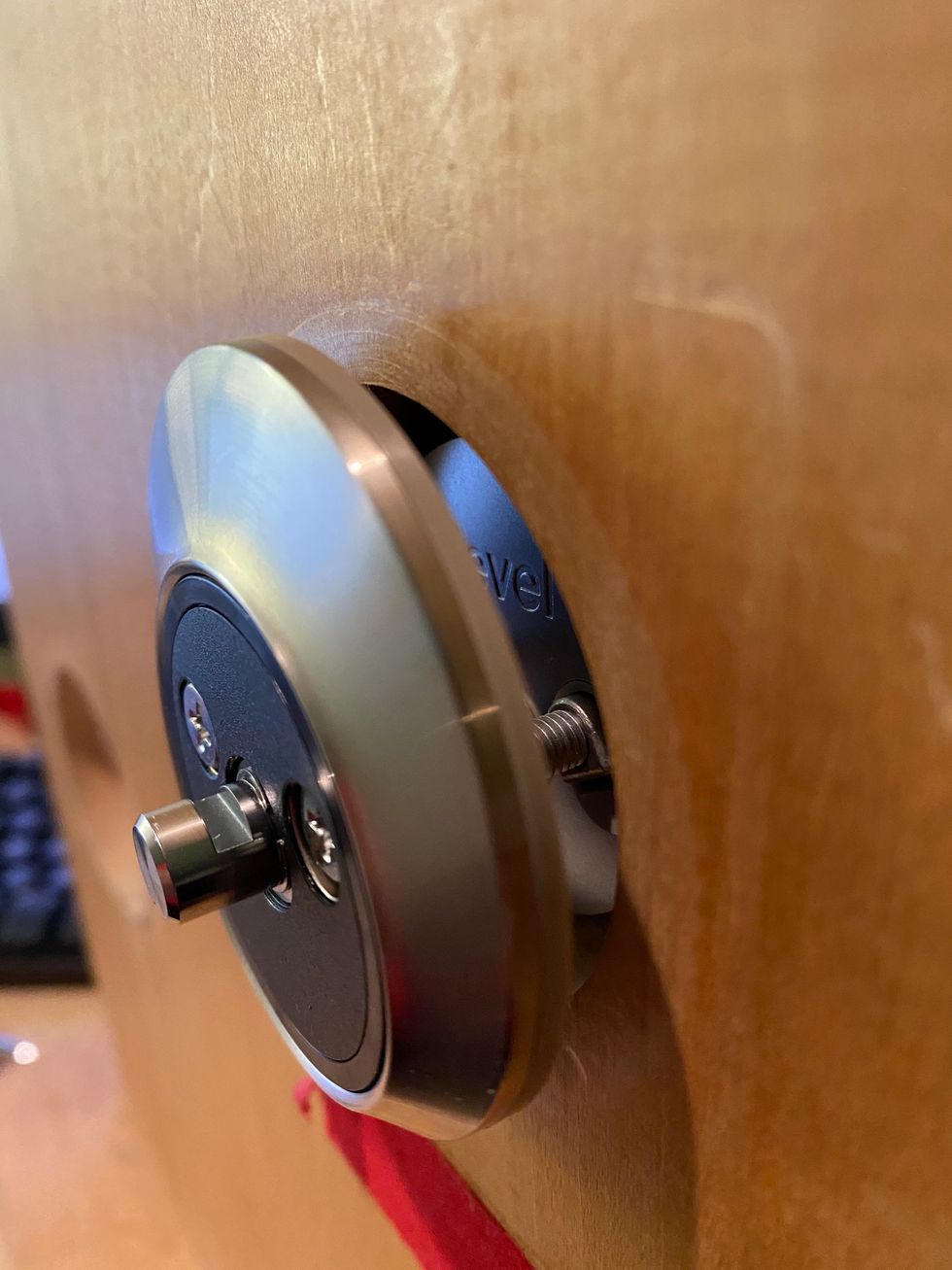 A photo of backside of Level Touch slightly installed on a door showing no cords