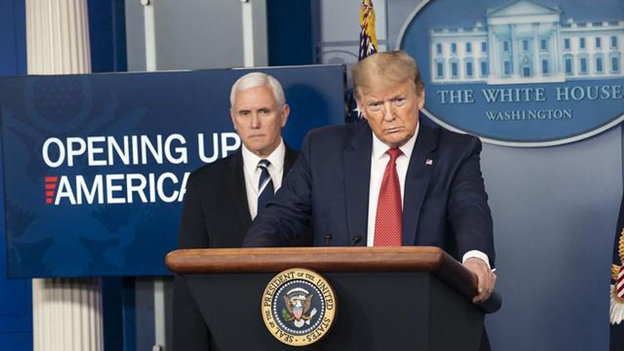 Donald Trump stands at podium, with Vice President Mike Pence behind him.
