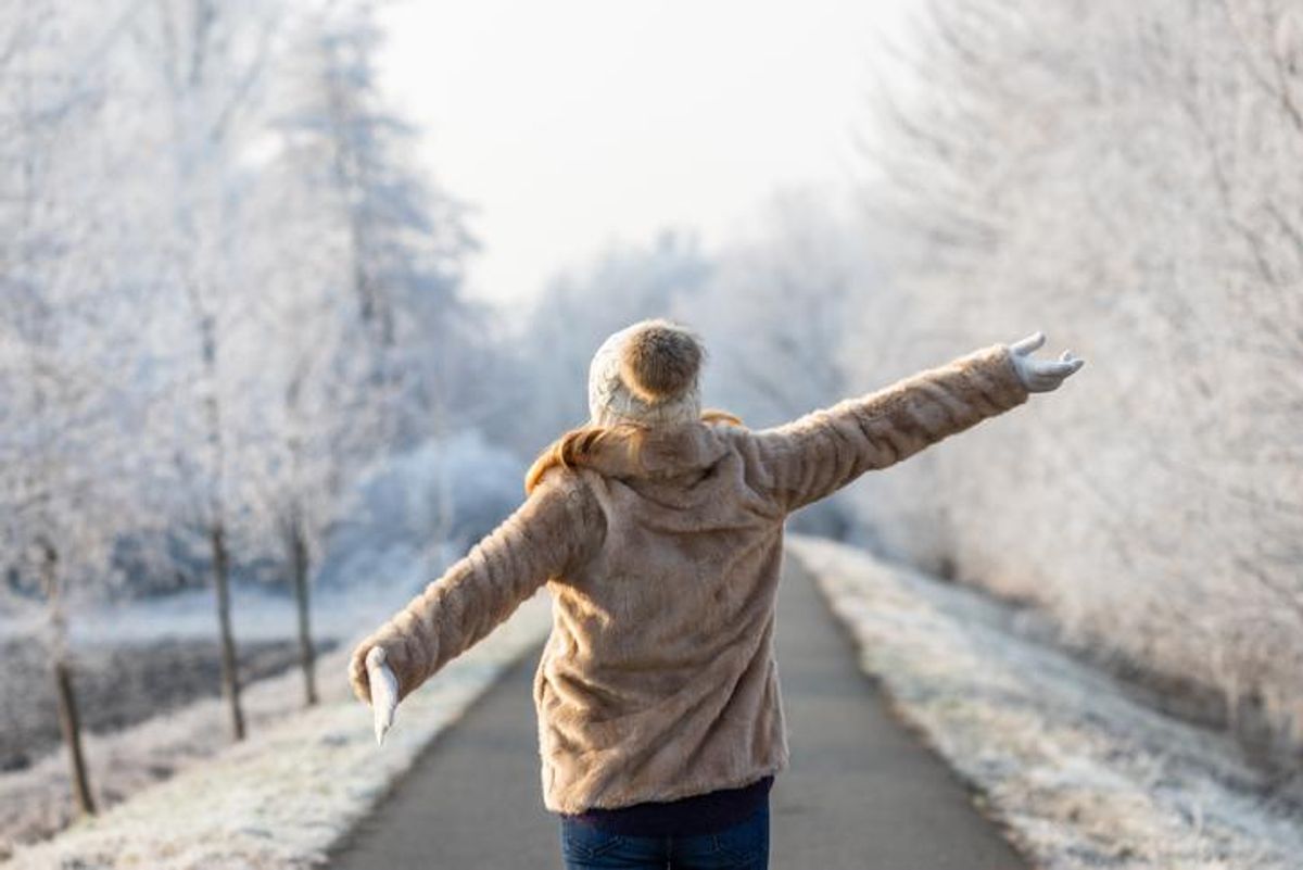 Someone dressed warmly outside in the winter snow