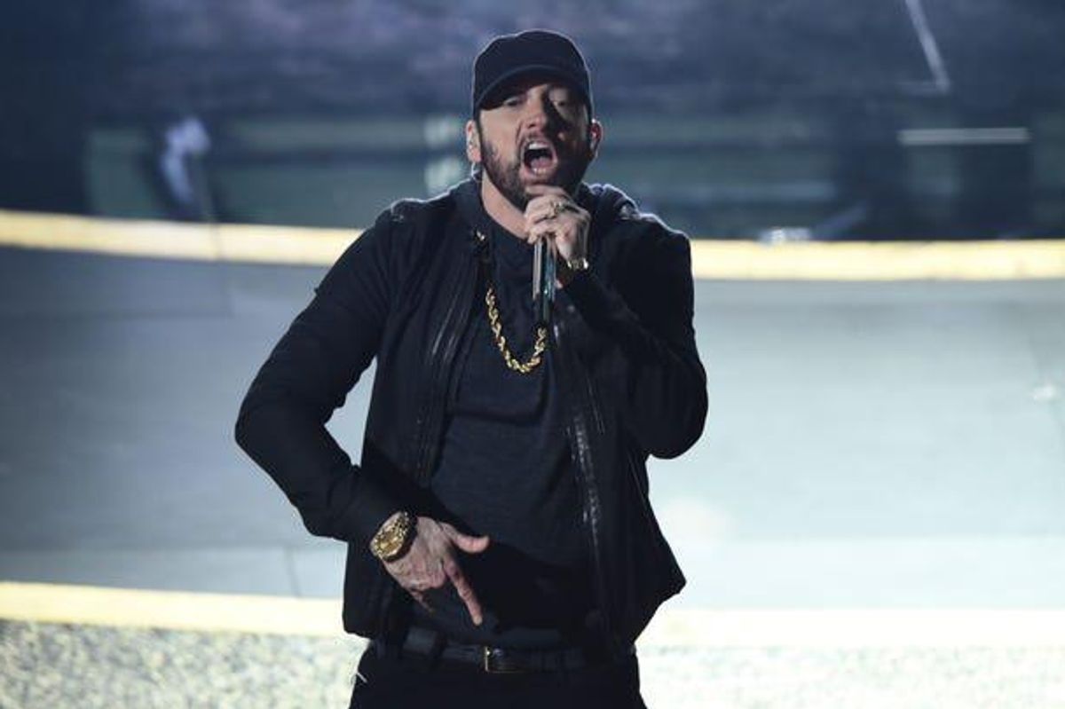 Eminem on stage holding a microphone rapping