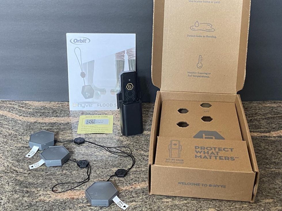 Orbit B-hyve smart flood sensor unboxed on a counter