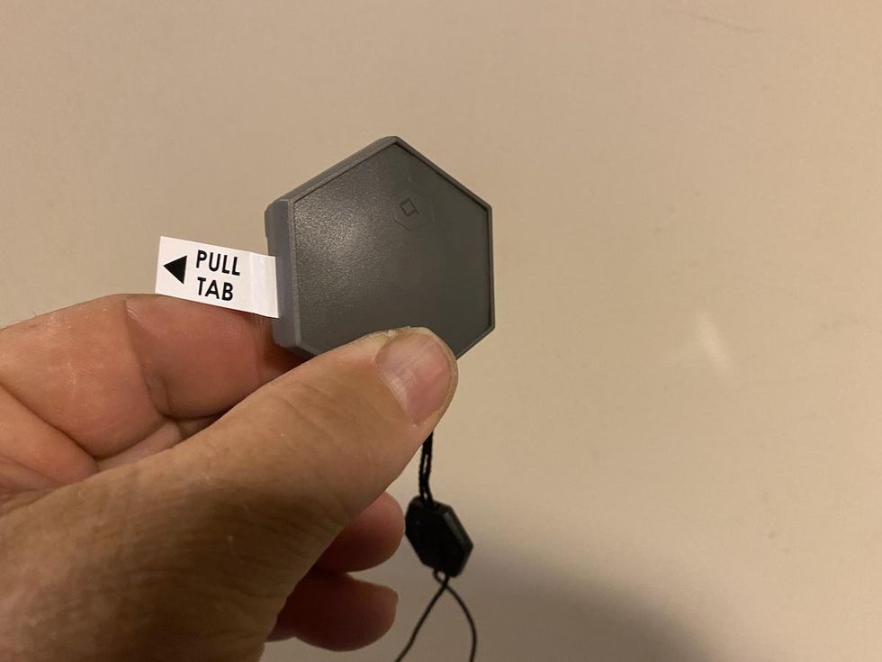 Photo of hand holding Orbit b-hyve smart flood sensor