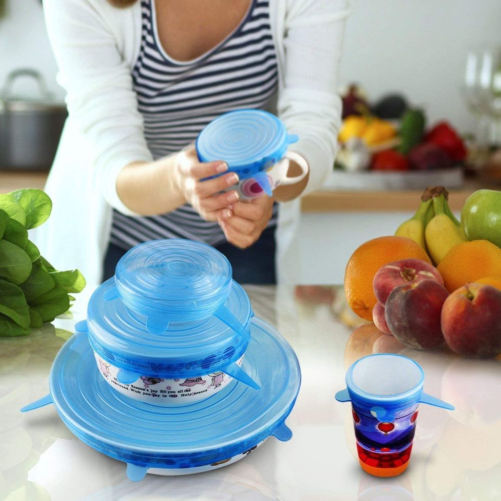 A women puts food huggers on leftovers.
