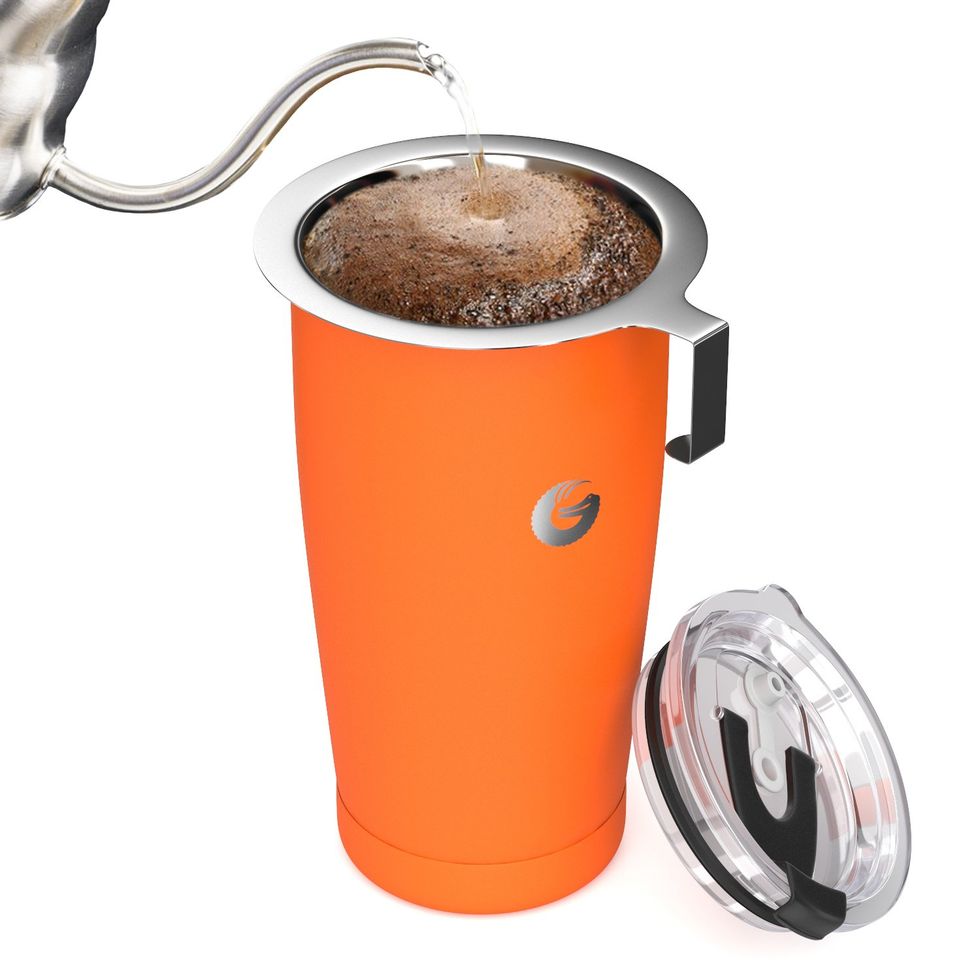 An orange pour over cup is filled with hot fresh coffee.