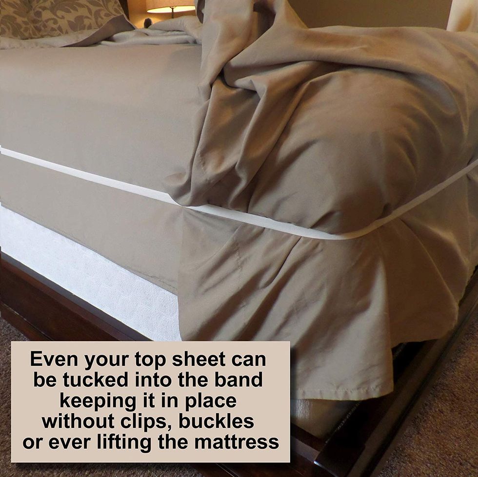 A band keeps a top sheet on a bed in place.