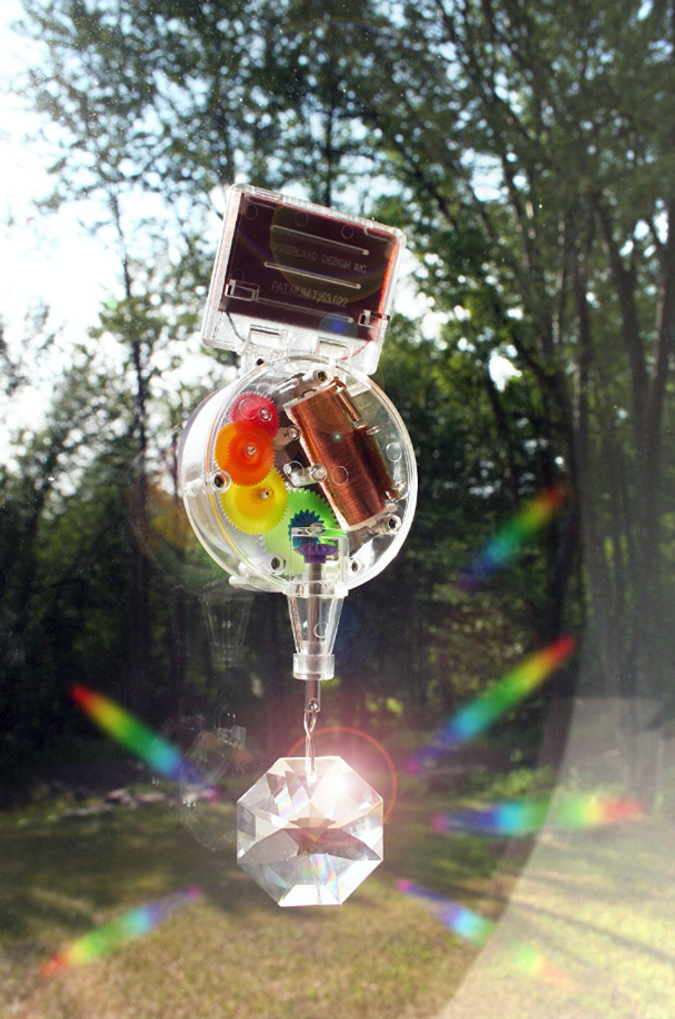 A rainbow maker outside creating multiple rainbows.