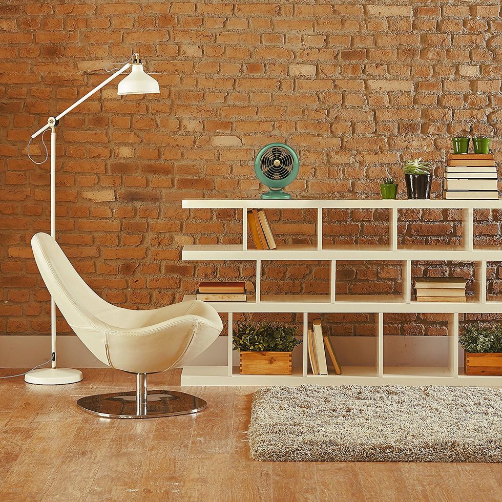 A living room with a brick wall and a modern organization sleeve.