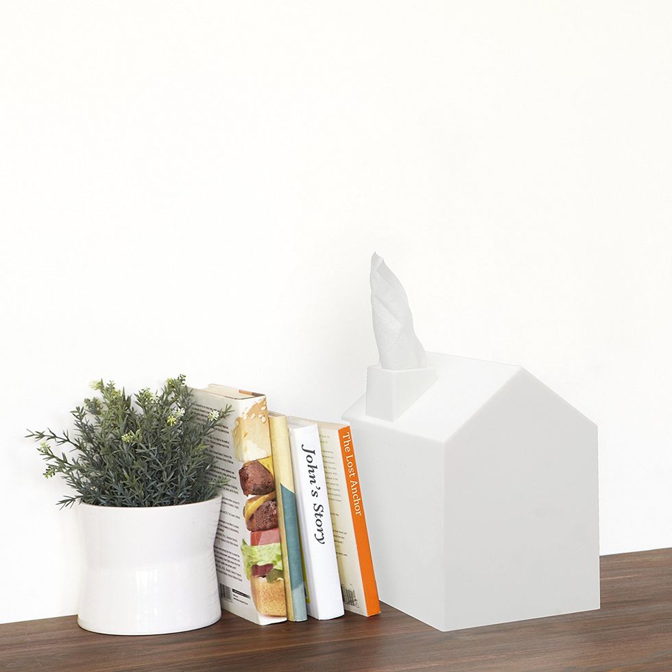 A tissue box holder that looks like a house.