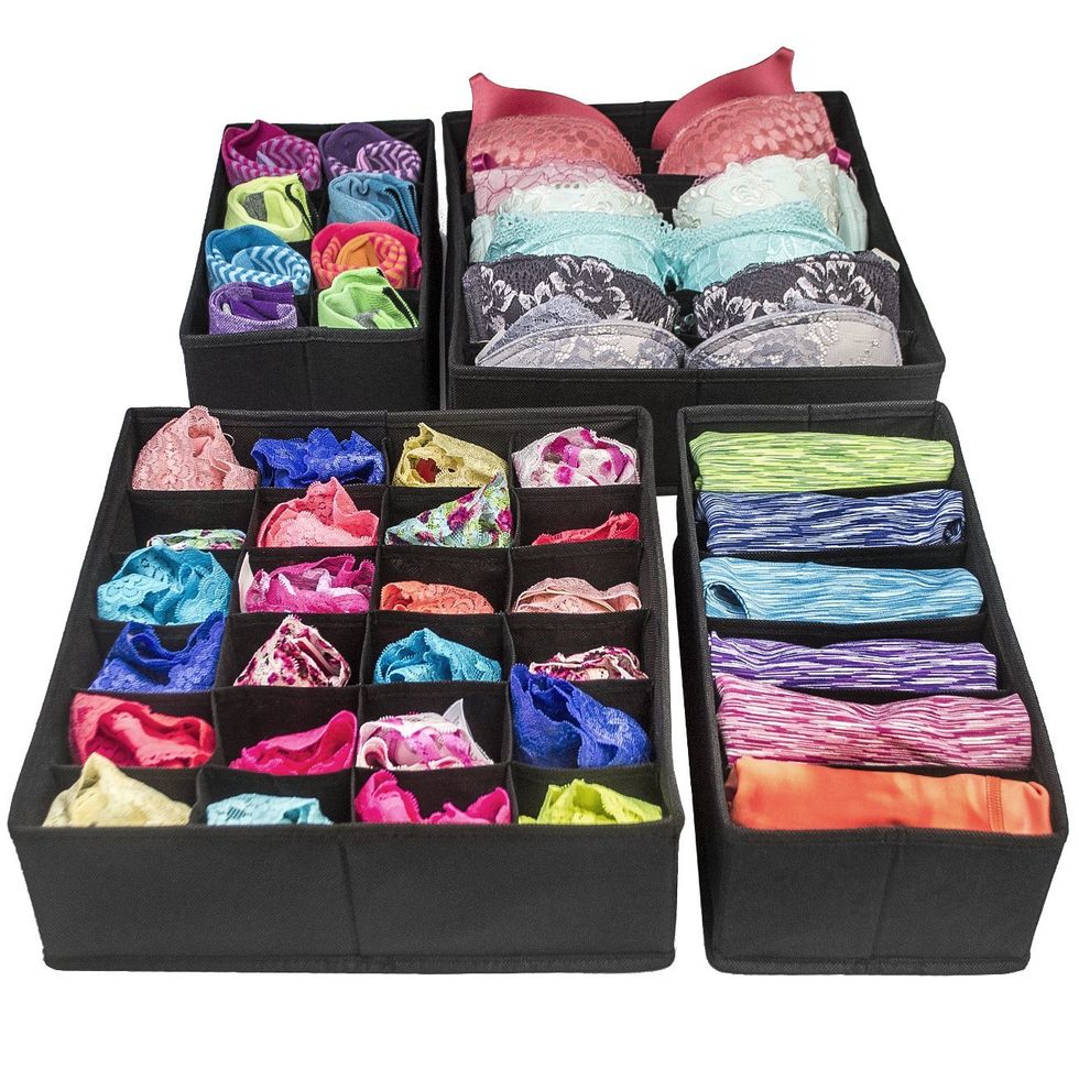 Drawer dividers holding various pieces of clothing.