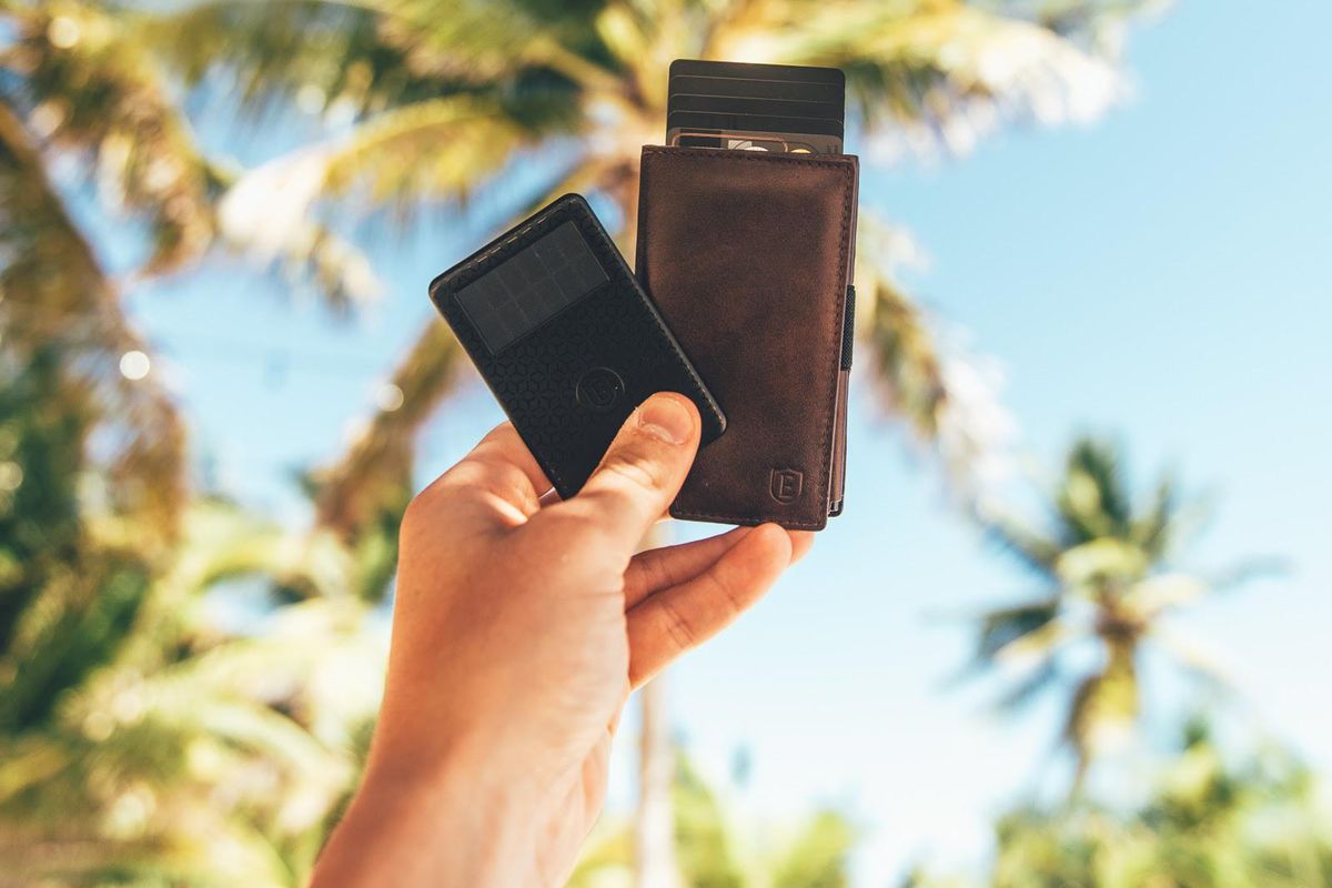 Ekster cardholder and tracker with palm trees in the background.