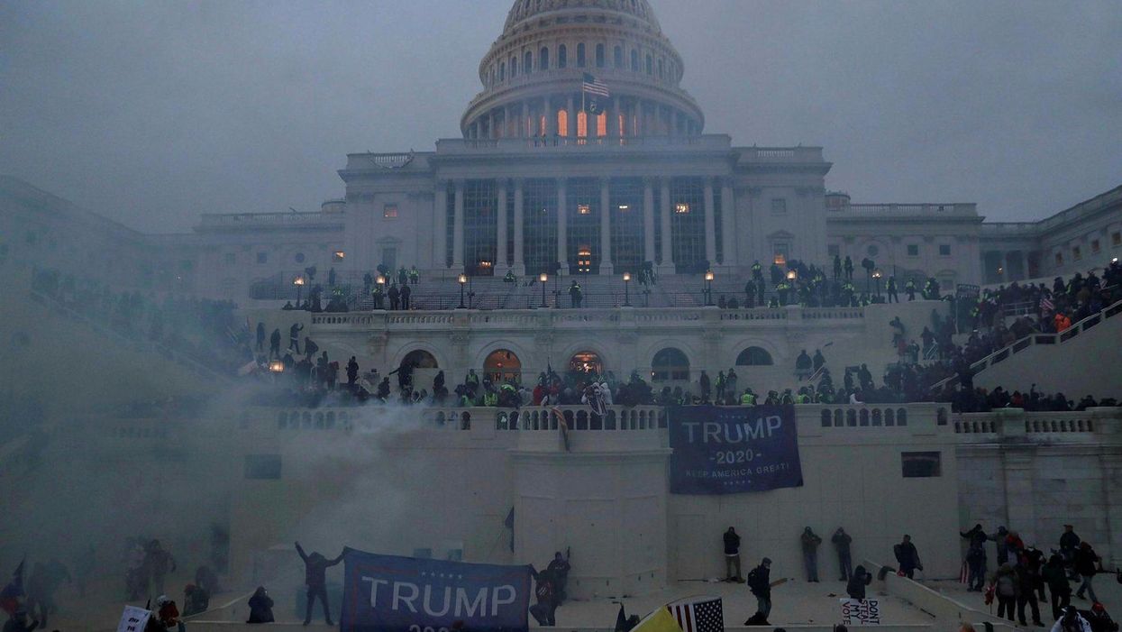 Violent Trump supporters attacking the Capitol.