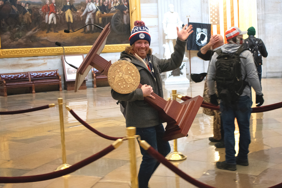 Trump Supporter Adam Johnson taking the Speaker's lectern from the House of Representatives