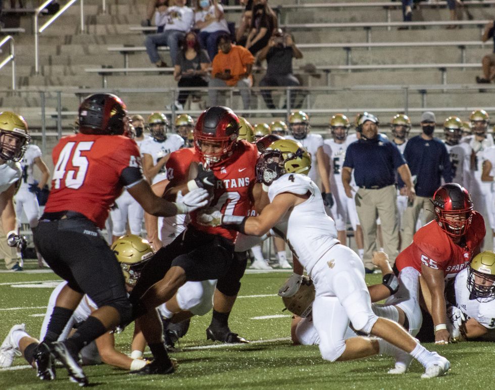 Josh Evans-Pickens, #10 fights his way to gain yardage.