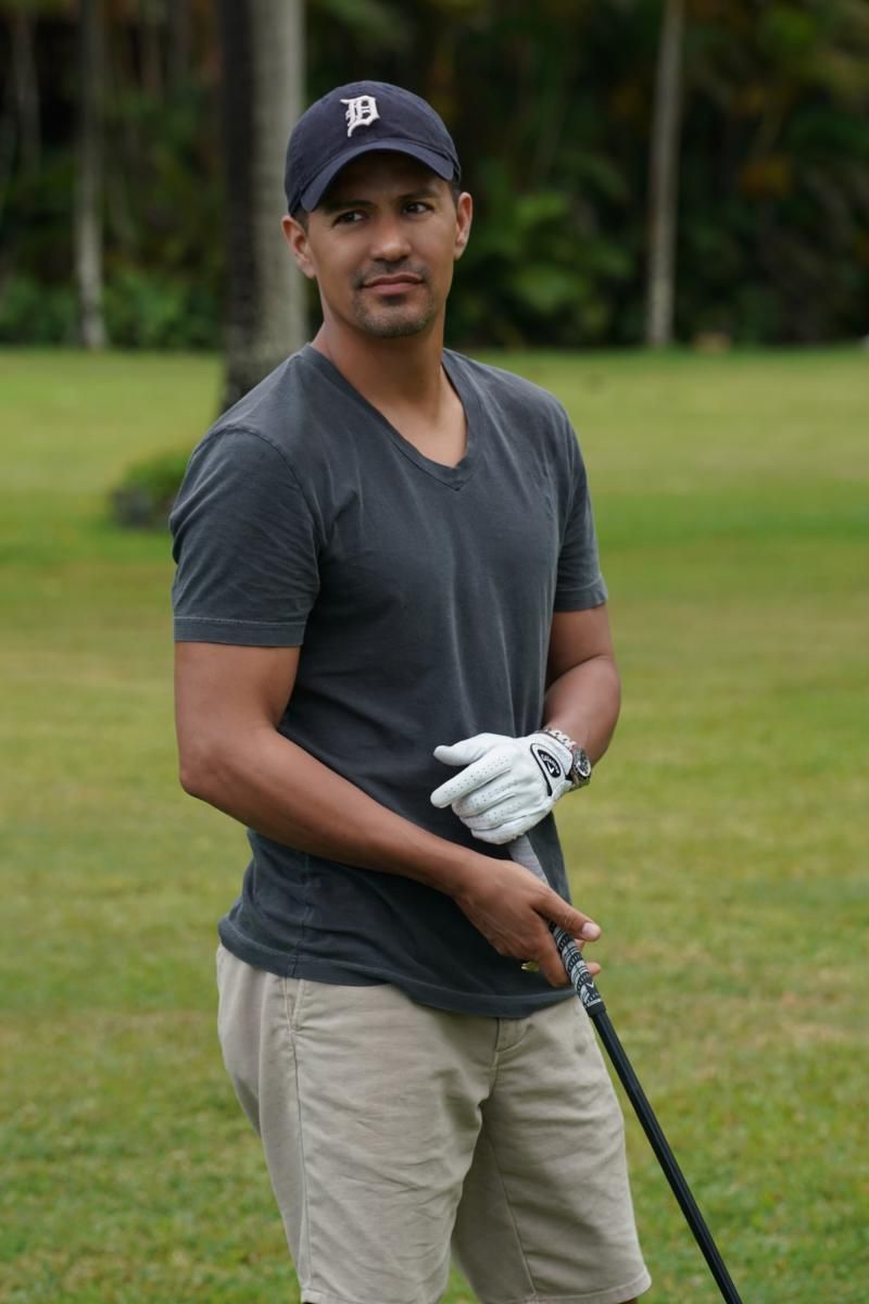 Magnum with a golf club and glove in a Detroit Tigers baseball cap