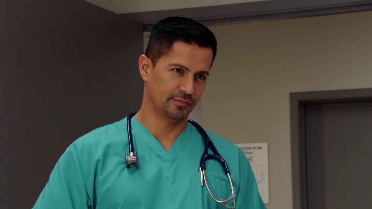 Magnum in medical scrubs with a stethoscope around his neck