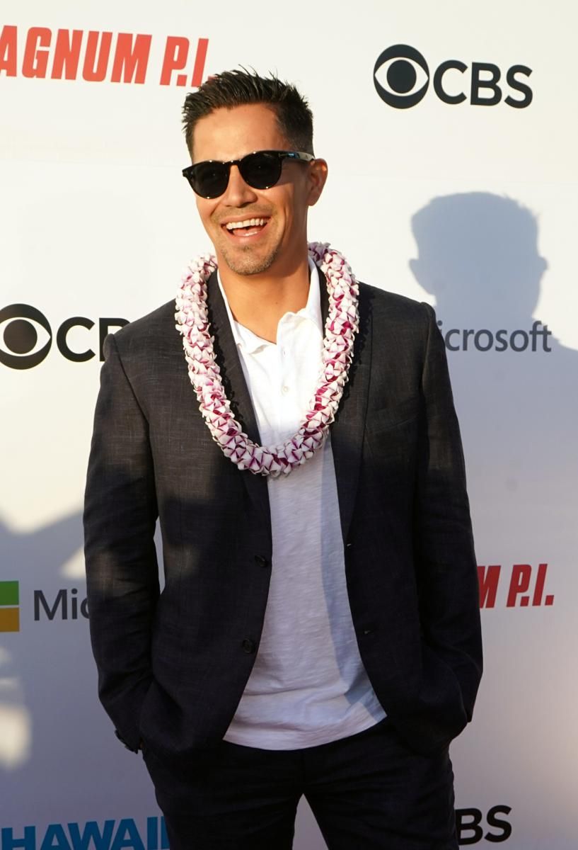Jay Hernandez on the red carpet in sunglasses and a flower lei