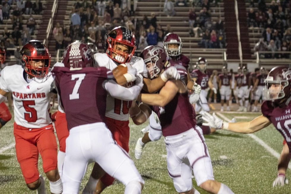 Josh Evans-Pickens, #10 fights for more yardage up against Magnolia's defense.