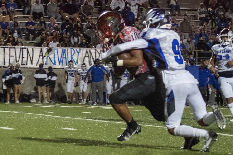 Josh Evans-Pickens, #10 fights his way for more yardage against New Caney's defender.