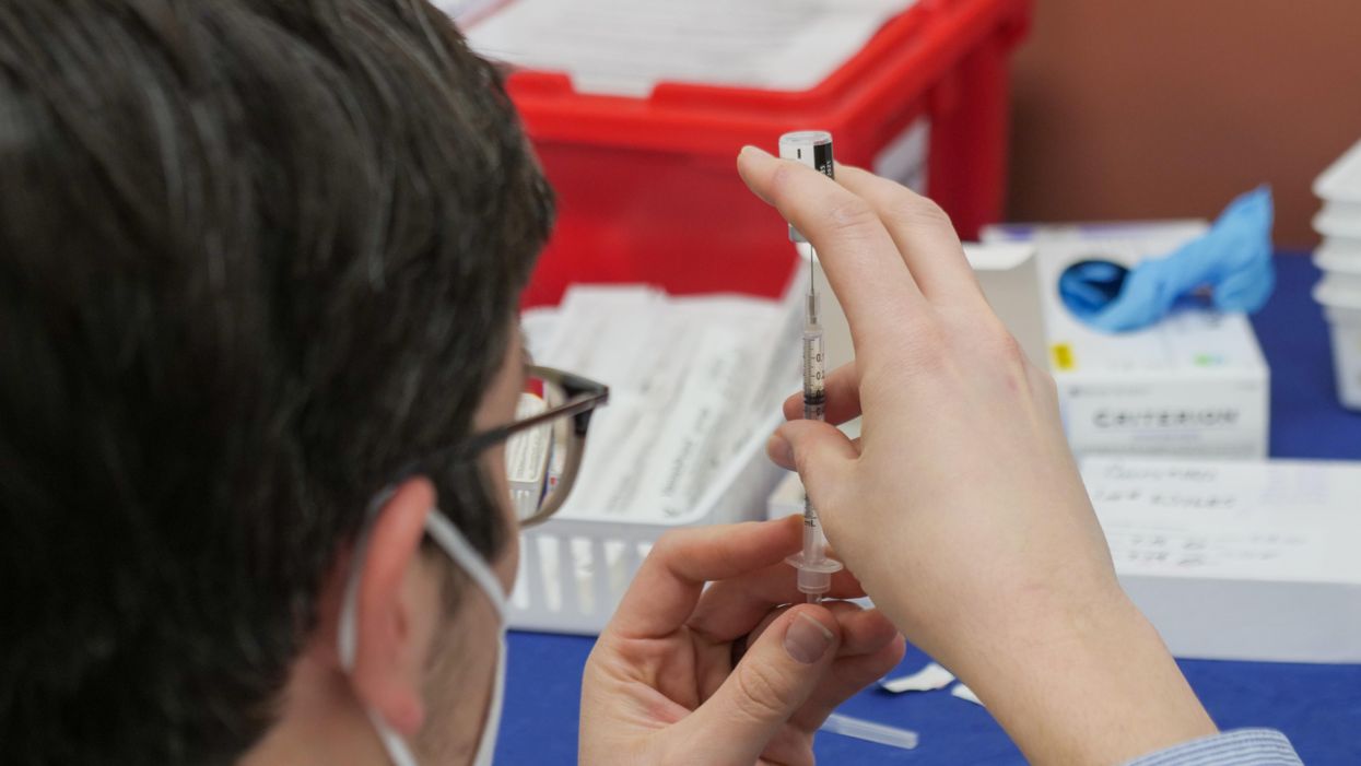 Pharmacist preps Covid-19 vaccine 