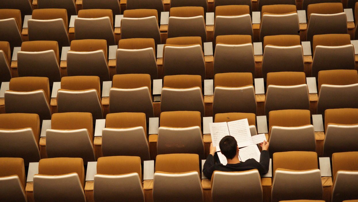 College student in empty auditorium 