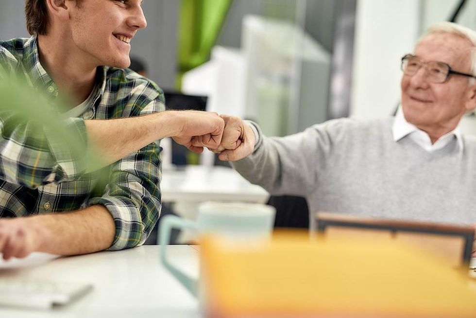 Manager fist bumps an intern