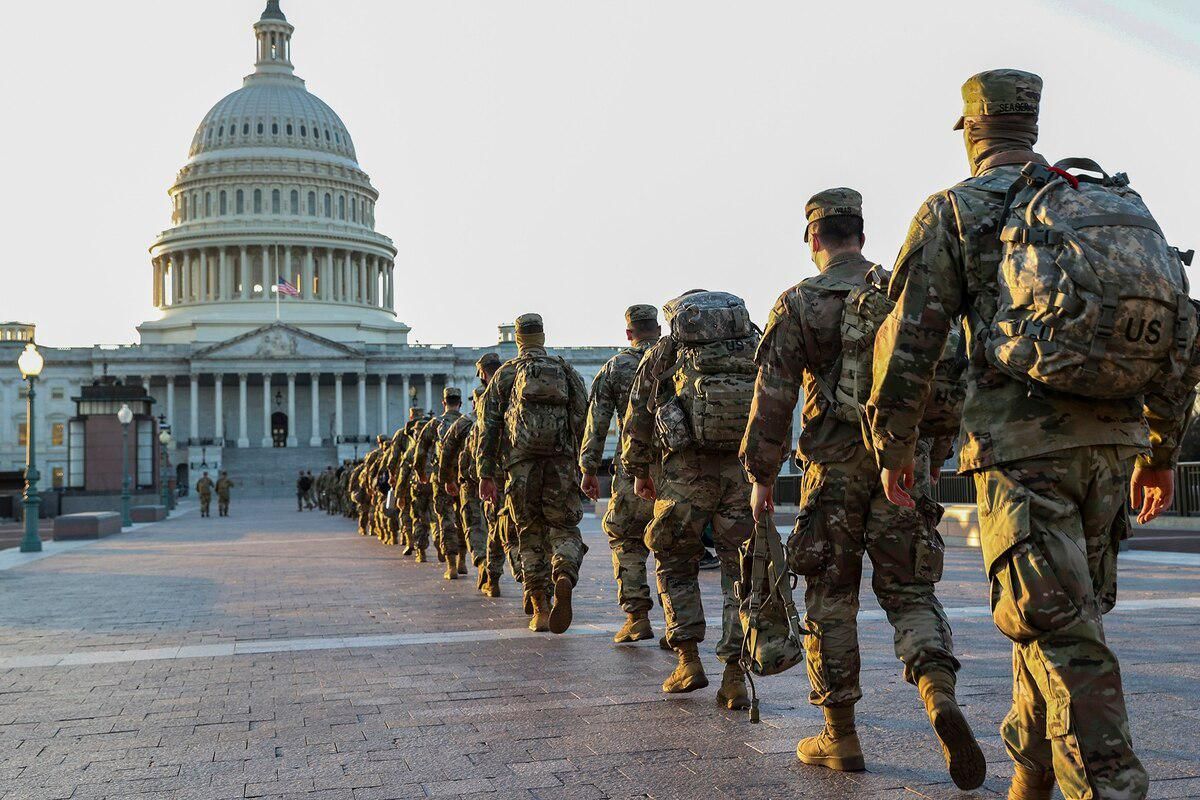 National guard soldiers walking in a line to the U.S. Capitol building