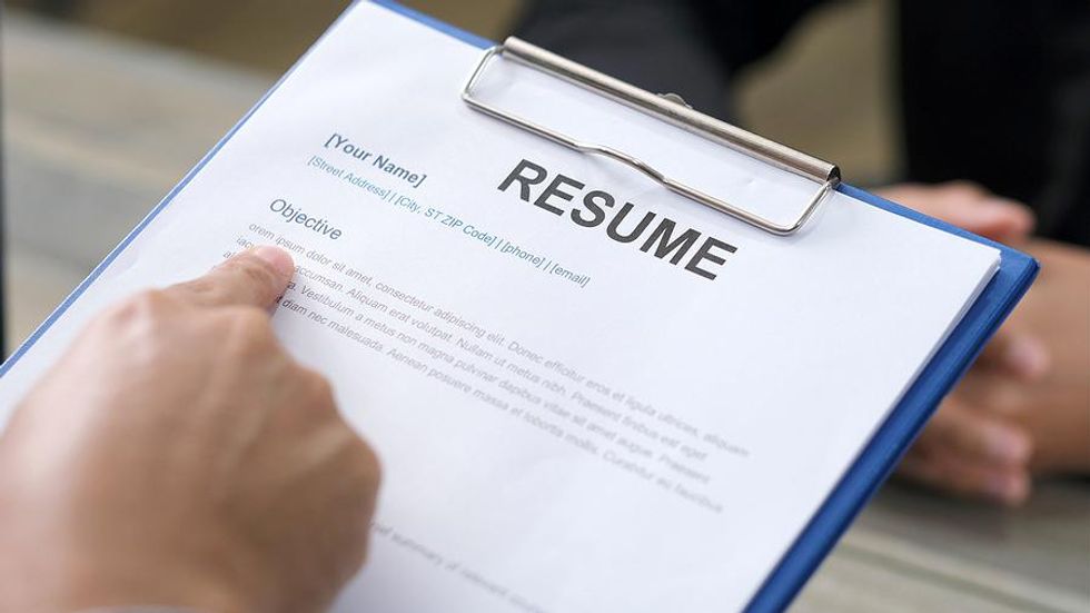 Hiring manager checks a job candidate's resume for proper grammar
