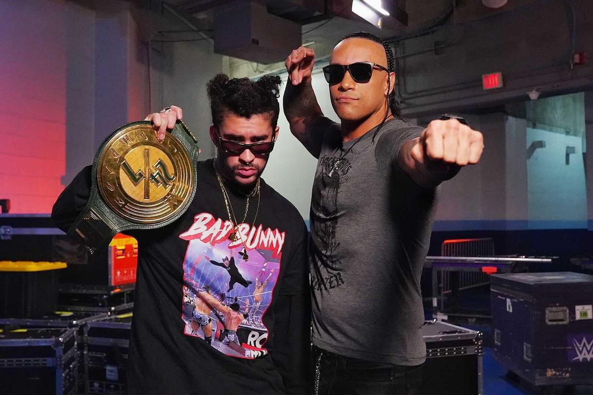 Bad Bunny holding the WWE 24/7 Championship along side Damian Priest